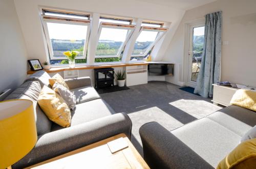 a living room with a couch and a table at Fell View Retreat in Ambleside