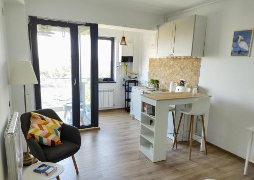 una pequeña cocina con mesa y barra en Retro Studio by the SEA, en Eforie Nord