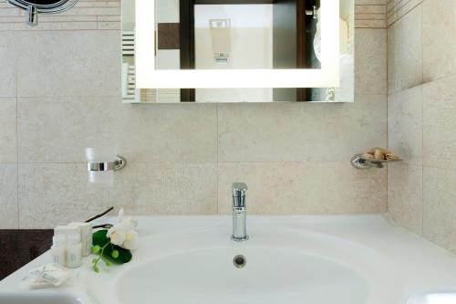 a bathroom sink with a mirror and a sink at Yes Hotel Boutique Rome in Rome