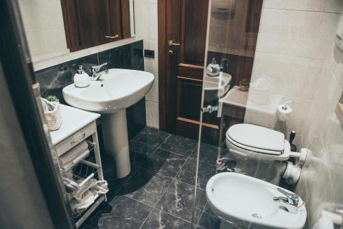 a bathroom with a toilet and a sink at Verona in musica apartment in Verona