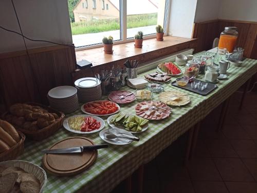 a long table with food on top of it at Penzion Jizera Malá Skála in Malá Skála