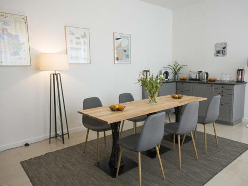 a dining room table with chairs and a lamp at La Chartreuse - Bordeaux in Bordeaux