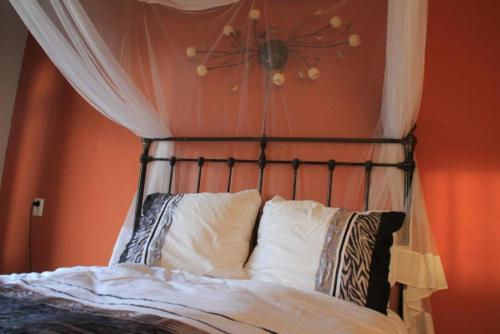 a bed with a black head board with white pillows at Waard van Kekerdom in Kekerdom