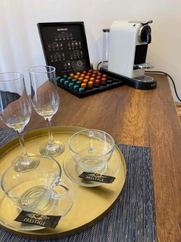 a tray with three wine glasses on a table at Prestige Apartment Teslic in Teslić