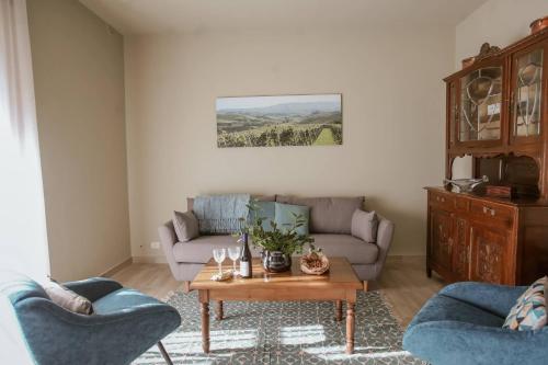 a living room with a couch and a coffee table at CA'du LIN - Jacuzzi e Piscina in Cisterna dʼAsti