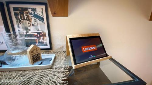a lap top computer sitting on a table next to a picture at Sohana Lifestyle Apartments I Stefan's Home I Rust in Rust