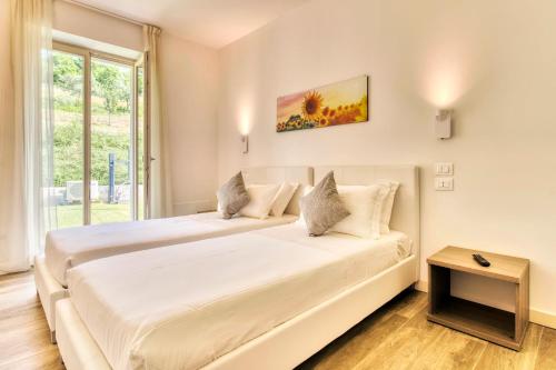 En eller flere senger på et rom på Villa Brusadela Suites Garda