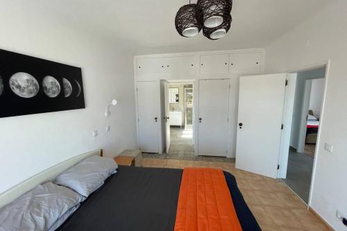 a bedroom with a bed with an orange blanket at Spacious Villa. Large Rooftop. 4 Bedroom Sleeps 8 in Alvor