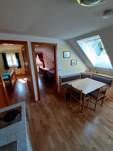 a living room with a table and a skylight at Schilcherweinbau Vollmaier vlg. Wieser in Sankt Stefan ob Stainz
