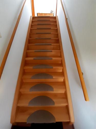 a staircase with wooden steps in a room at Schilcherweinbau Vollmaier vlg. Wieser in Sankt Stefan ob Stainz
