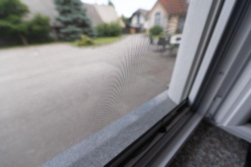 a window with a view of a street at Apartmaji in sobe RaMar in Straža
