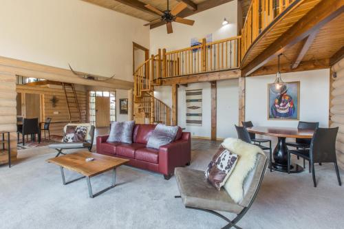 a living room with a red couch and a table at 317 Tower Main House in Ridgway