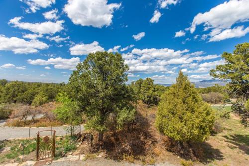 a view of trees and a blue sky with clouds at 317 Tower Main House in Ridgway