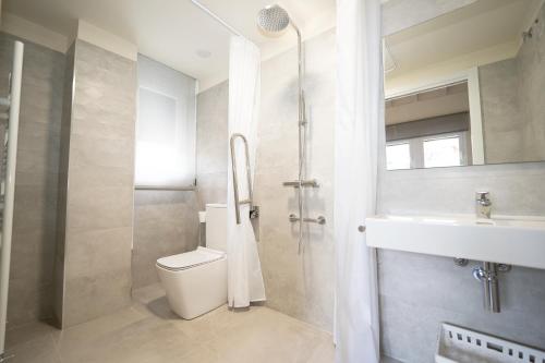 a bathroom with a toilet and a sink and a shower at Hotel Rural La Casa de Mis Abuelos in Navaleno