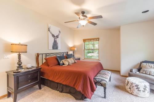 a bedroom with a bed and a ceiling fan at Elkhorn Townhome 1939 in Ouray