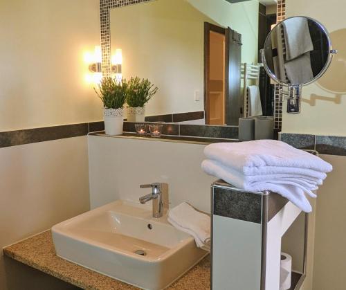 a bathroom with a sink and a mirror at Ferienwohnung Haus Aschauer in Oberau