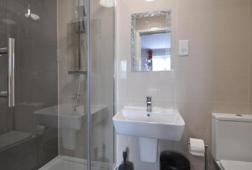 a bathroom with a sink and a shower and a toilet at King Hotel Tenterden in Tenterden