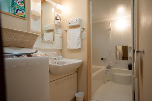 a small bathroom with a sink and a toilet at Kiyomizu Machiya Inn in Kyoto