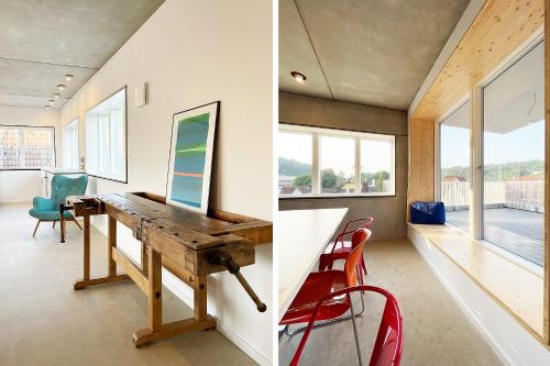 a home office with a wooden desk and red chairs at Serviced Apartments - Penthouse im Herzen Königsbronns in Königsbronn