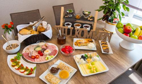 a table with many plates of food on it at Hotel Garni am Eckernweg in Celle
