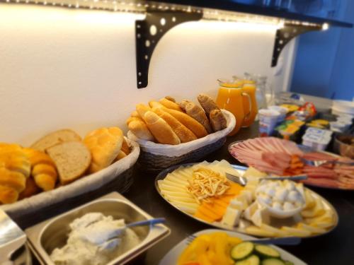 a table with plates of food on a counter at Rezidence Sunny Hill in Frymburk