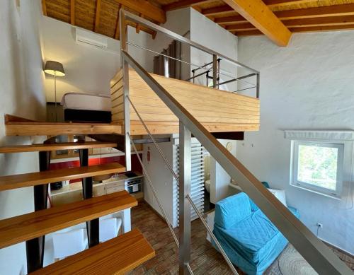 a spiral staircase in a tiny house at Casas Do Moinho - Turismo De Aldeia in Odeceixe