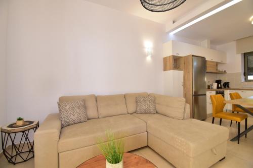 a living room with a couch and a kitchen at Kallixeni Villas in Rethymno Town