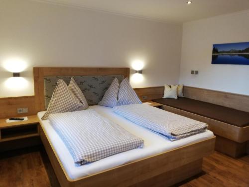 a bedroom with a large bed with two pillows at Landhaus Gruber Sommer in Sankt Johann im Pongau