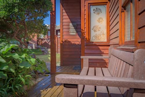 a bench sitting on the porch of a house at Shick-Shack in Eersterivierstrand