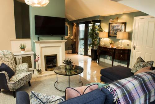 a living room with a couch and a fireplace at The Heritage in Killenard