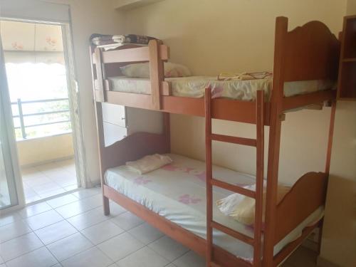 a bedroom with two bunk beds in a room at Saranda Backpackers in Sarandë