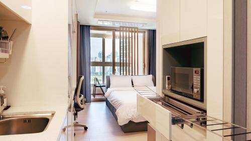 a bedroom with a bed and a television in a room at The November Stay In landmark in Incheon