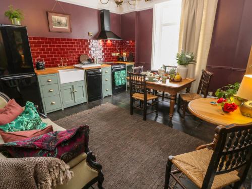 a kitchen with a table and a dining room at Dreytop in Ryde