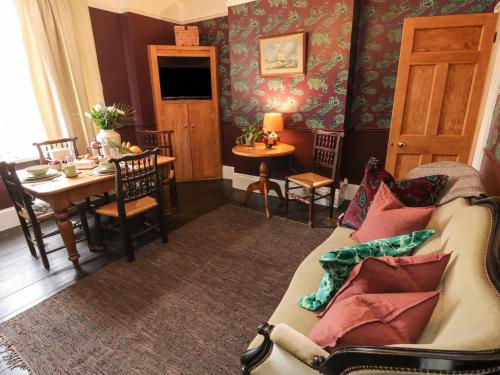 a living room with a couch and a table at Dreytop in Ryde