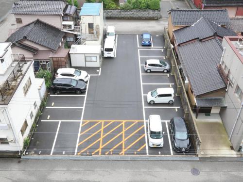 an aerial view of cars parked in a parking lot at APA Hotel Uozu Ekimae in Uozu