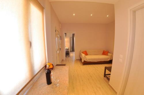 a bedroom with a bed and a room with a hallway at Dina's Paradise in Agios Gordios