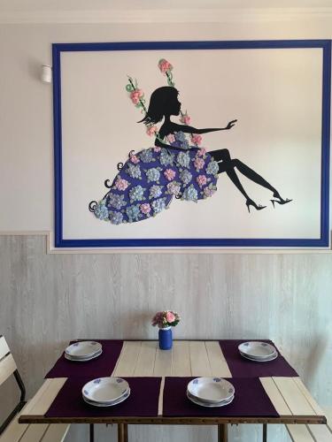 a picture of a woman in a dress on a table at Flower Breeze in Chebanka