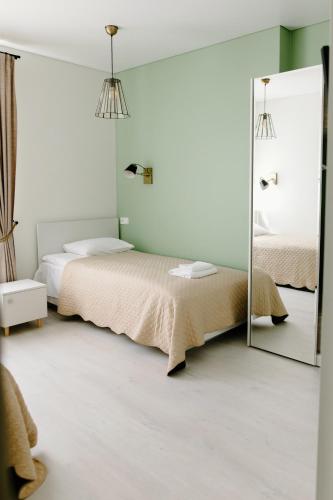 a bedroom with two beds and a mirror at Green Town in Vievis