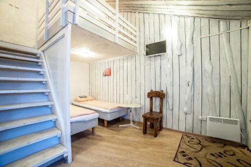 ヴィボルグにあるАпарт-коттедж Jasmine-mini с зоной барбекю рядом лес и гора Выборгの二段ベッドと階段が備わる小さな客室です。