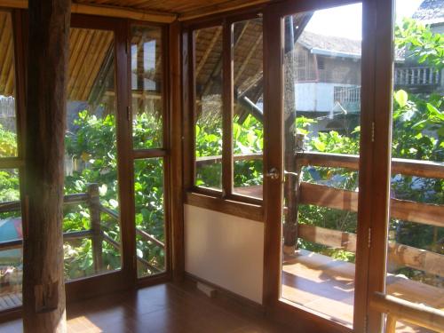 an open door to a room with windows at Paras Inn Boracay in Boracay