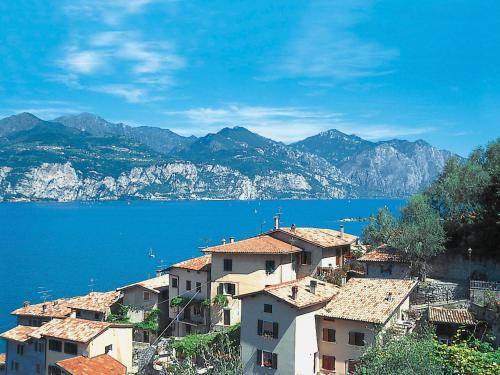 a group of houses on a hill next to the water at Apartment Casa Vigna by Interhome in Sommavilla
