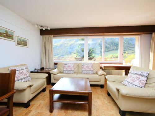a living room with couches and a large window at Apartment Ringstrasse Apt 212 by Interhome in Leukerbad