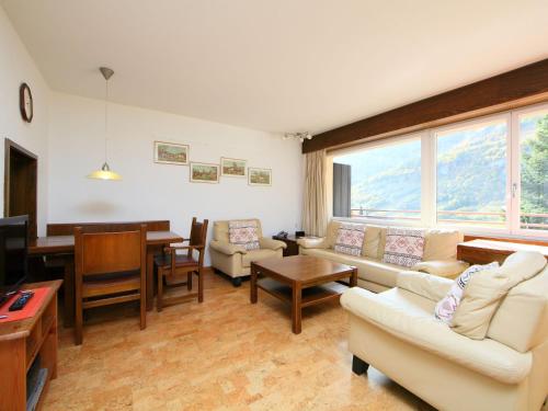 a living room with couches and a dining room at Apartment Ringstrasse Apt 212 by Interhome in Leukerbad