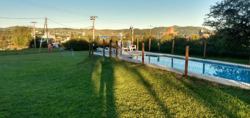 a yard with a swimming pool and a playground at La Rosada in Potrero de Garay