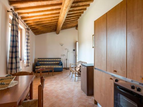 a kitchen and living room with a couch and a table at Holiday Home Arancio by Interhome in Preselle