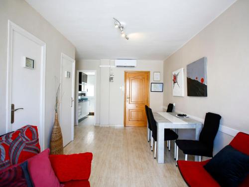 a living room and dining room with a table and chairs at Apartment Solmar by Interhome in Gandía