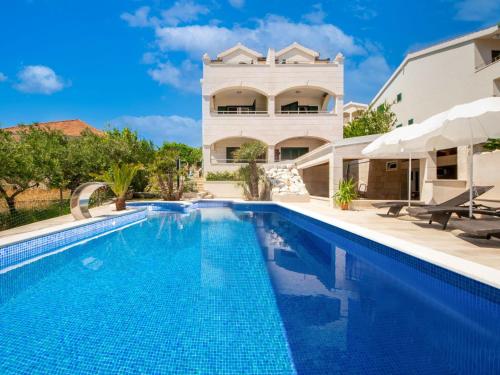 a swimming pool in front of a villa at Apartment Villa Andjelka-7 by Interhome in Trogir