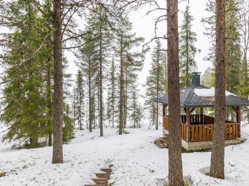a gazebo in the woods in the snow at Holiday Home Ruskatupa by Interhome in Ruka