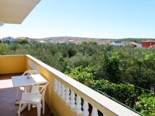 een balkon met een tafel en stoelen en uitzicht bij Apartment Dora - RAB142 by Interhome in Rab