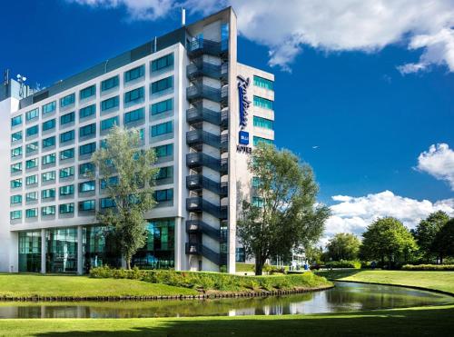 a building with a river in front of it at Radisson Blu Hotel Amsterdam Airport, Schiphol in Schiphol